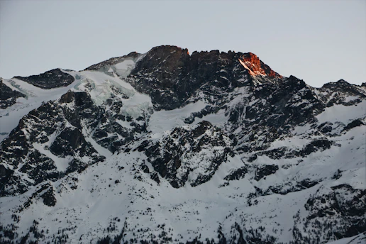A rugged mountain peak at dawn, symbolizing resilience and new beginnings.