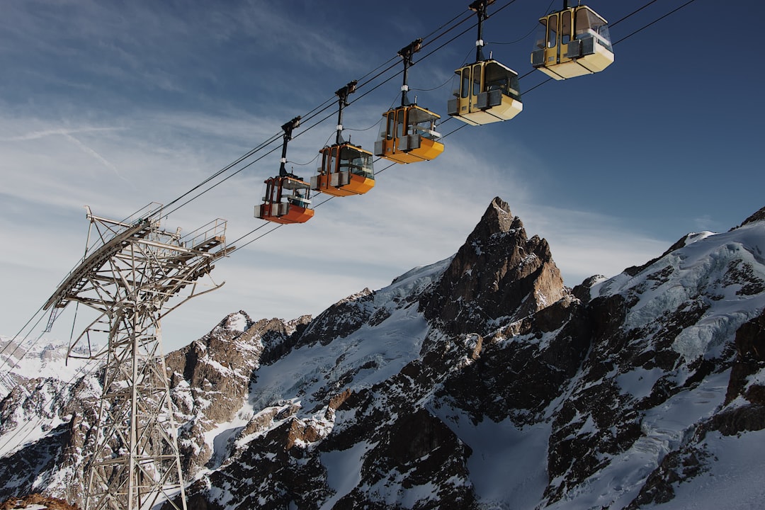 cable cars on air near rock formations,
