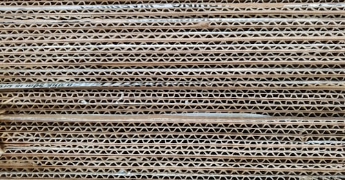 Close-up of corrugated cardboard showing the fluted medium layer