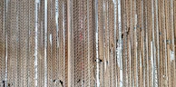 A stack of sturdy corrugated cardboard sheets neatly arranged, highlighting texture and quality.