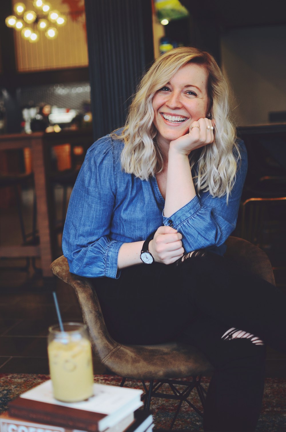 smiling woman sitting on chair inside room