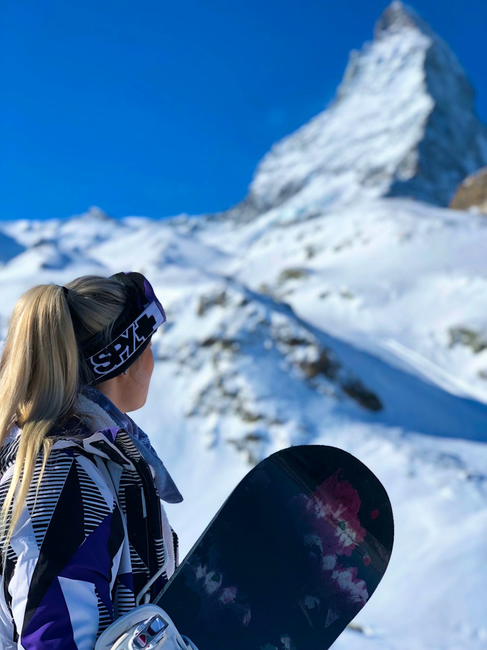 woman holding snowboard