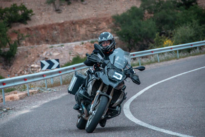 A focused rider practicing safe motorcycle handling on a winding Overberg road.