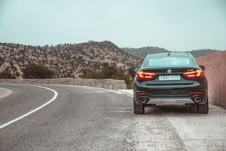 An impressive BMW X6 driving through a cityscape.