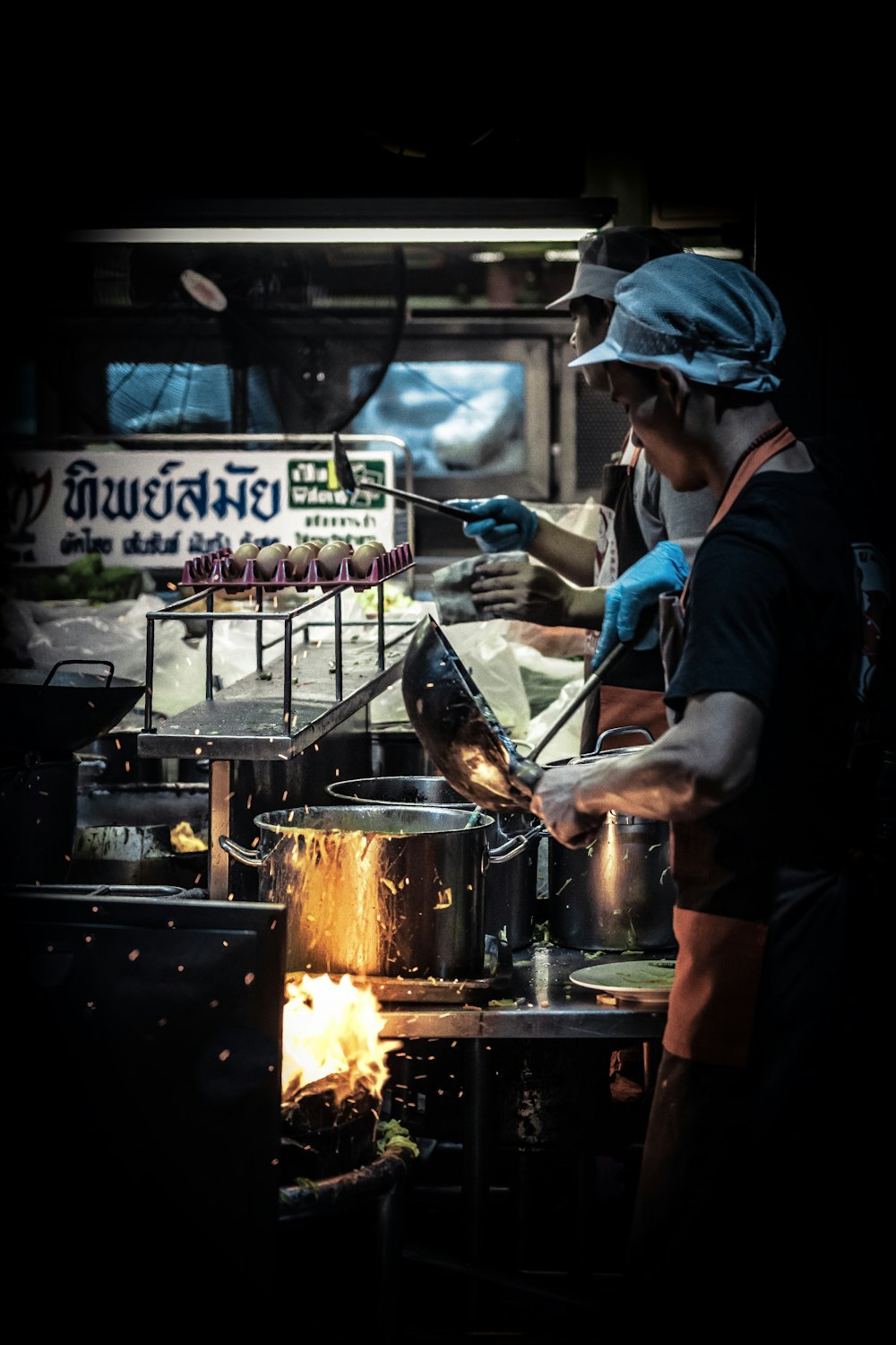 two men wearing black top cooking