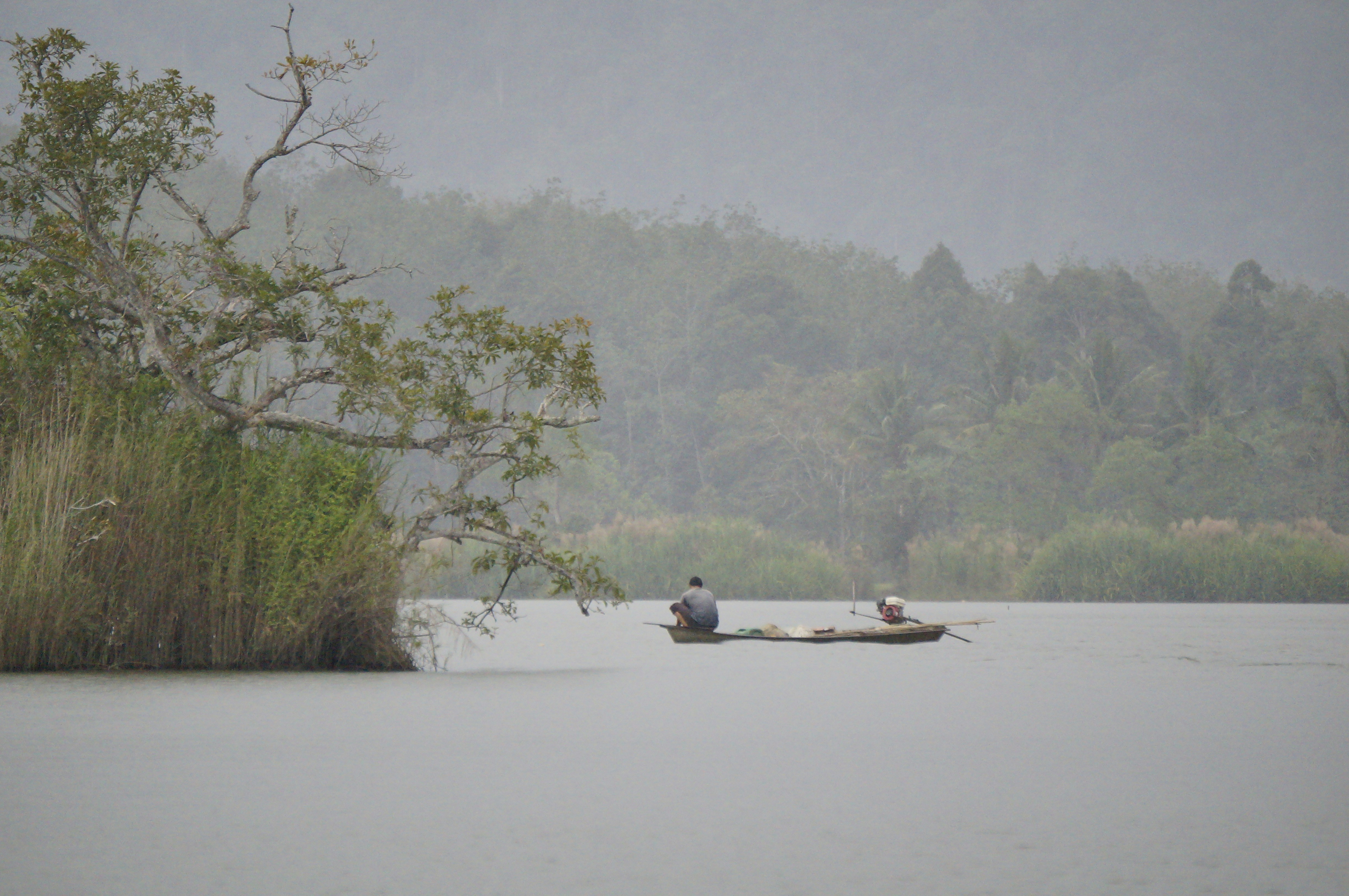 person riding canoe on calm body of water, 