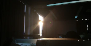 Soft morning light streaming through a cozy living room with a toddler playing quietly on a rug.