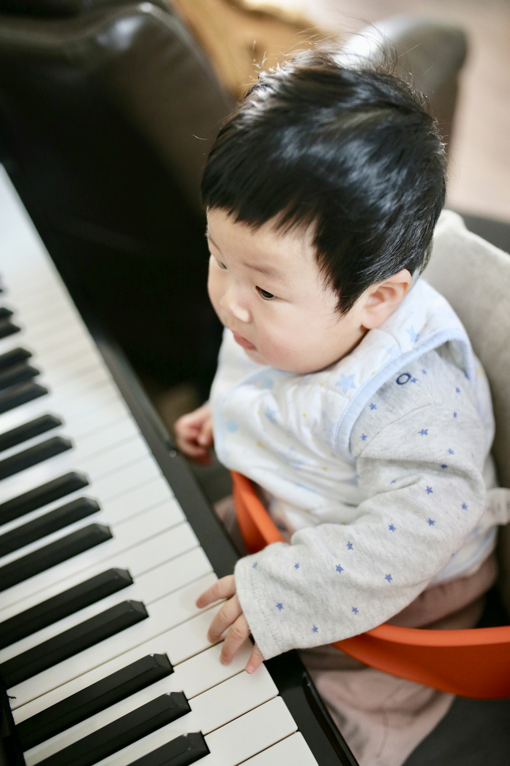 boy sitting in front of piano