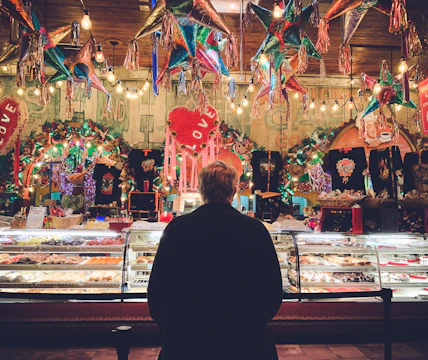 A vibrant bakery storefront decorated for a community event, attracting a crowd of happy customers.