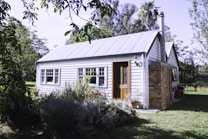 green grass across white bungalow house
