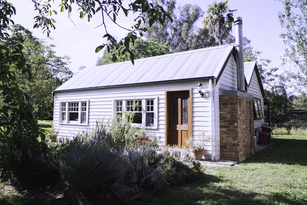 Hierba verde a través de la casa de bungalows blancos