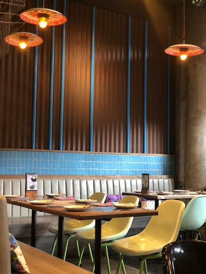 A warm, inviting Yemeni restaurant interior with traditional decorations and a table full of colorful dishes.