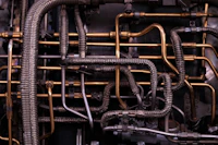 brass-colored and black metal tubes