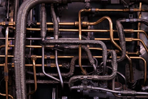 brass-colored and black metal tubes