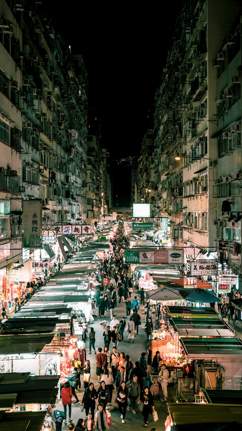 people walking on the streets between buildings