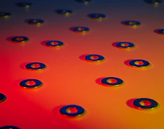 Close-up of shiny PEEK washers stacked neatly on a workshop table