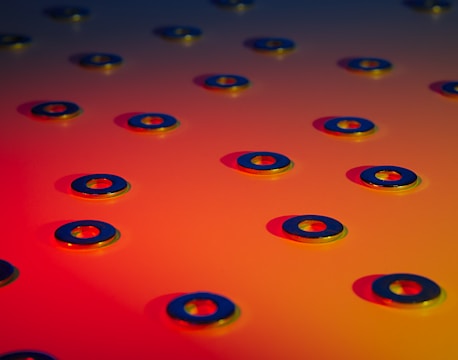 Close-up of shiny mild steel washers neatly stacked in a workshop.