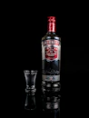 Smirnoff vodka bottle besides shot glass