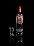 Smirnoff vodka bottle besides shot glass
