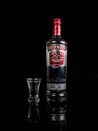 Smirnoff vodka bottle besides shot glass