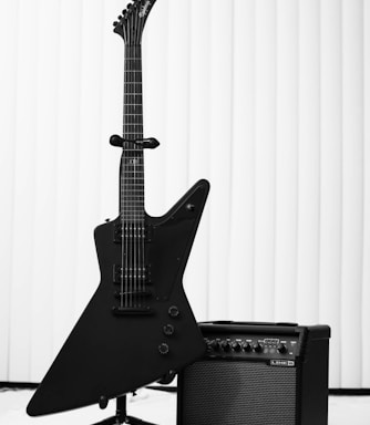 black electric guitar and amplifier