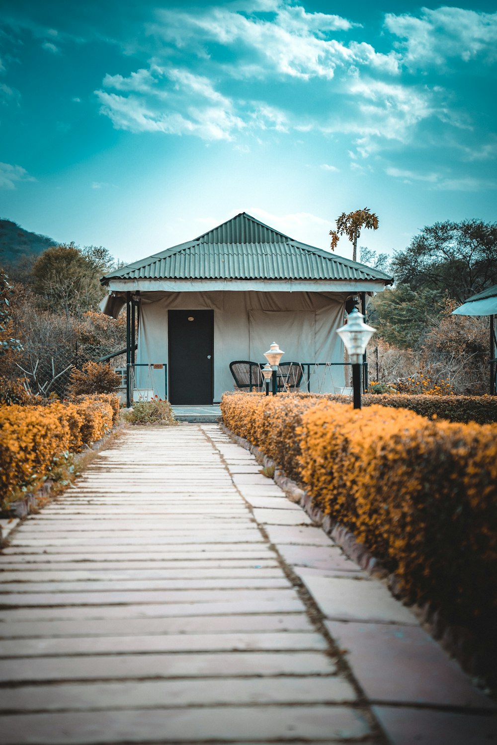 white wooden house under white clouds during daytime