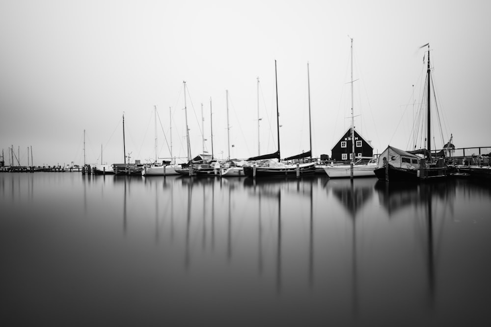 boats on body of water grayscale photo