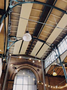 Renovated modern office interior with exposed steel beams and warm lighting.