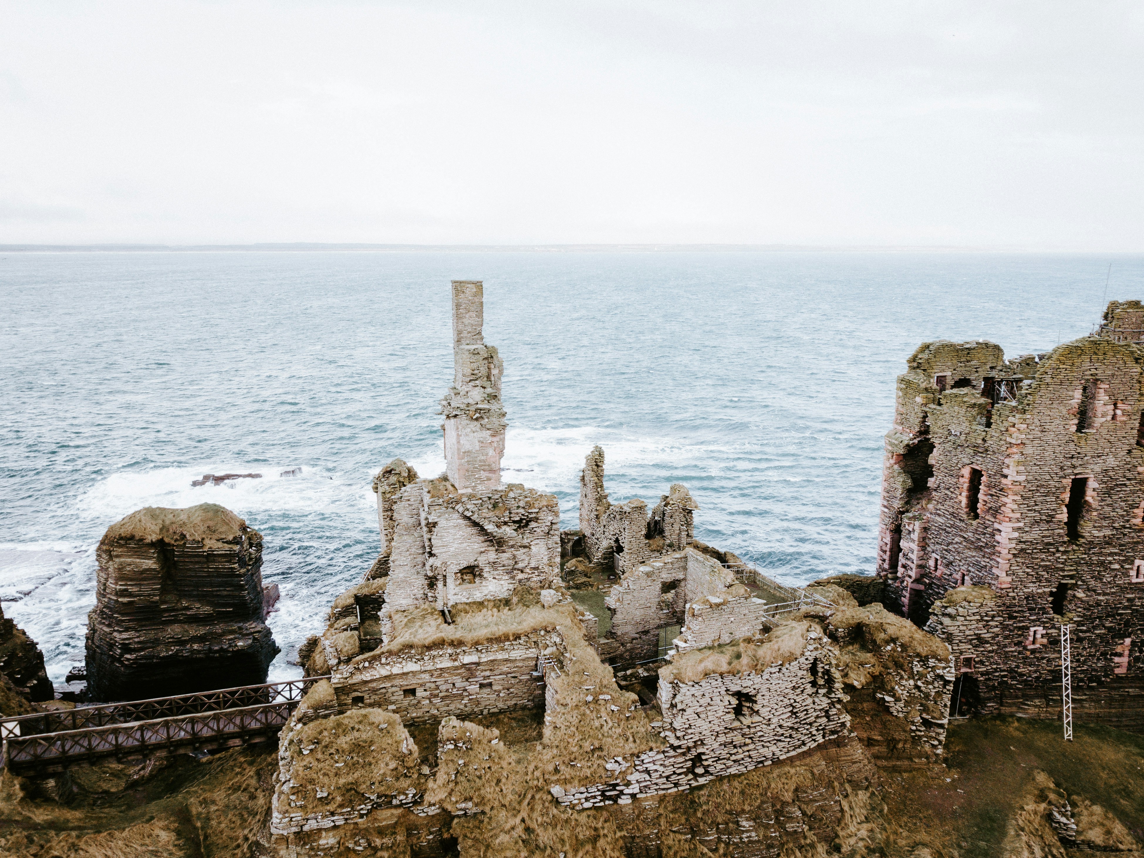 aerial photo of concrete abandoned buildings near sea at daytime