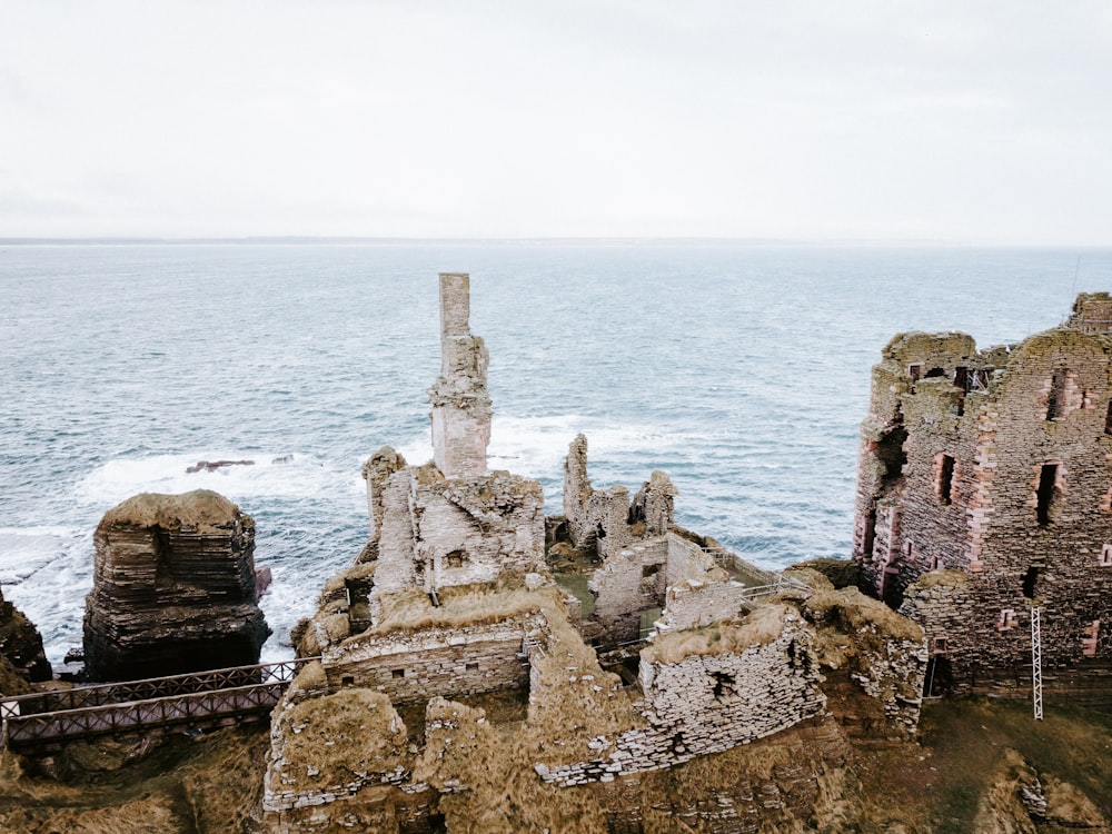 aerial photo of concrete abandoned buildings near sea at daytime