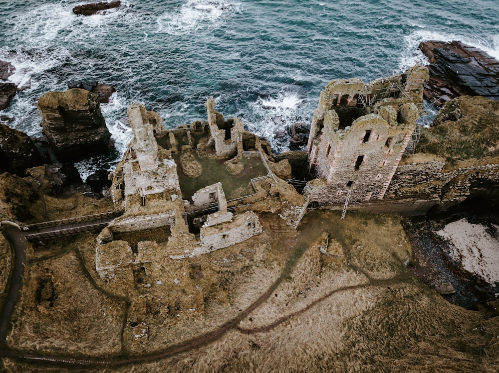 aerial photo of concrete abandoned buildings near sea at daytime
