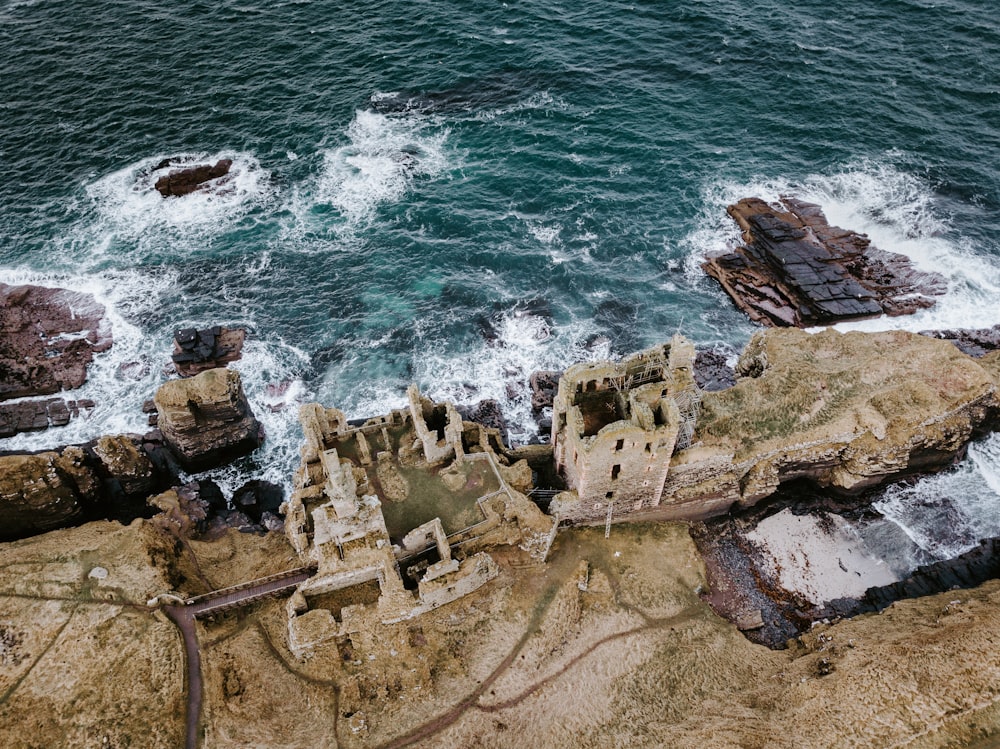 aerial photography castle beside body of water