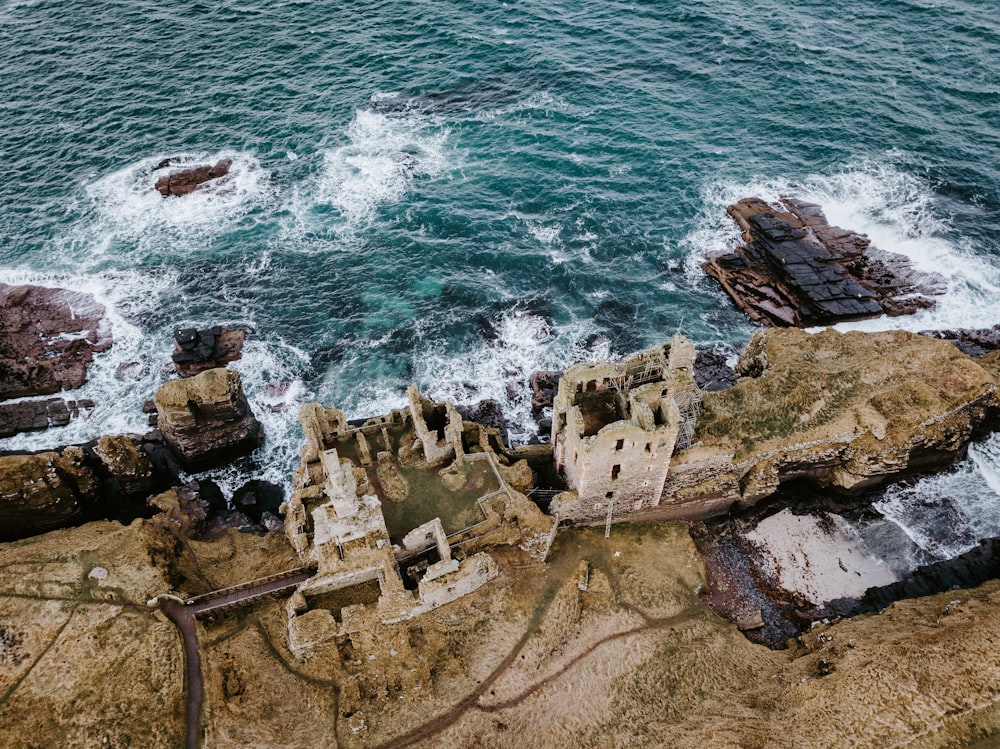 brown castle ruins across sea