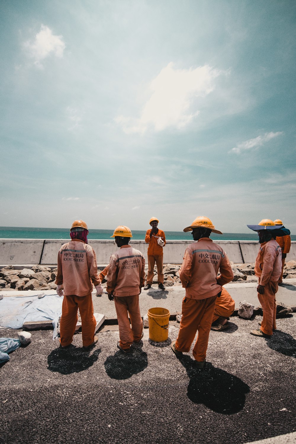 five person working road during daytime