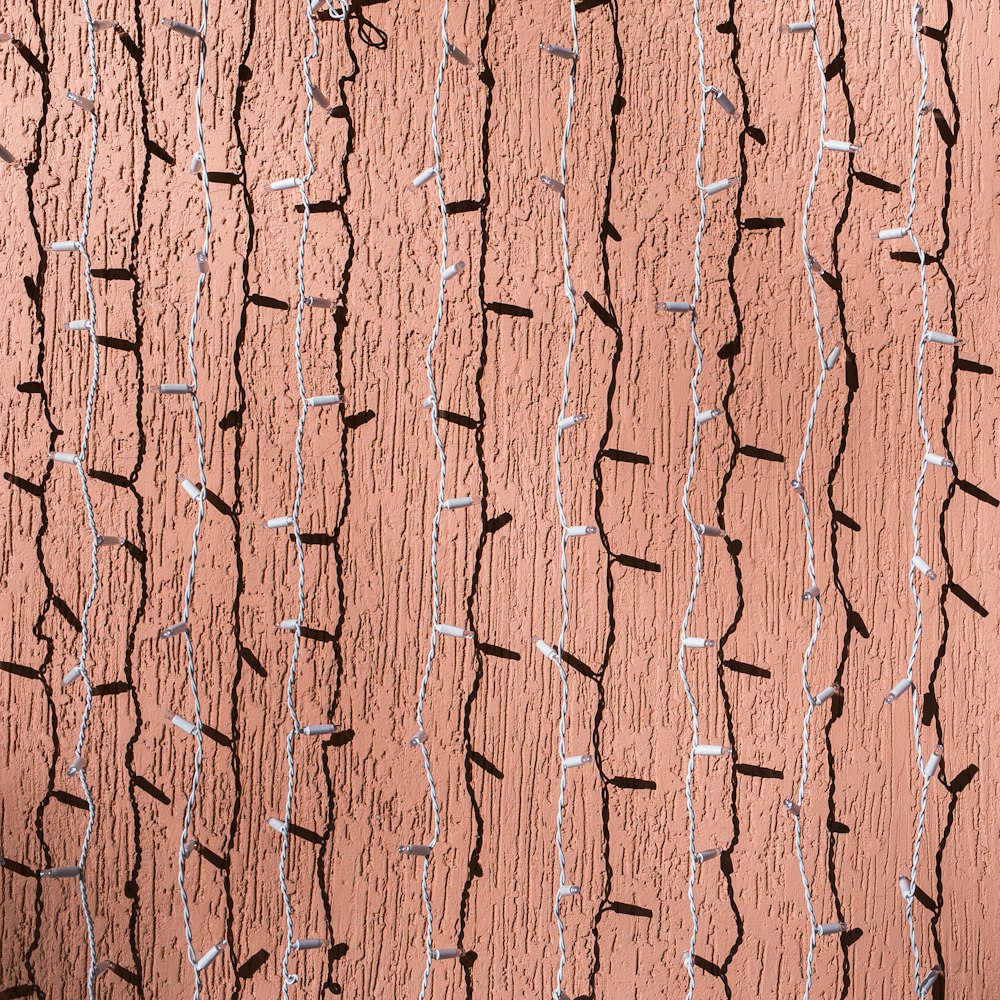 white string lights hanging across brown wall