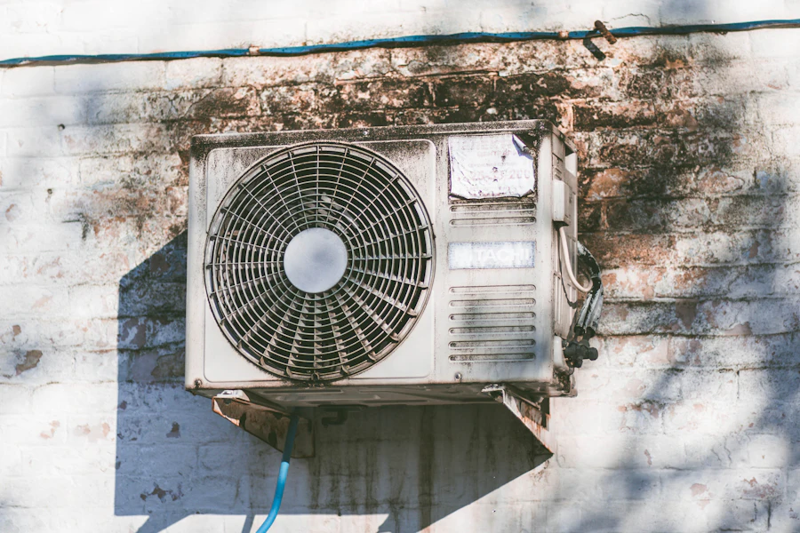 Residential outdoor air conditioning condenser mounted on an exterior wall