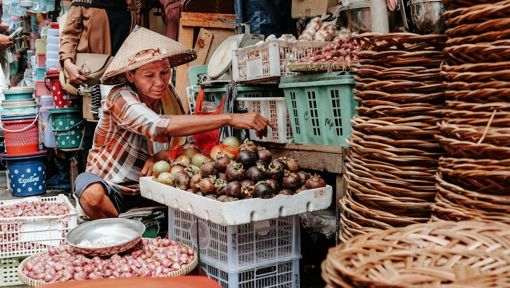 woman sitting beside variety of vegetables