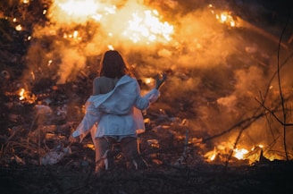 An inspiring image of a person in prayer surrounded by flames.