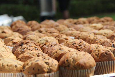 Assorted freshly baked muffins arranged elegantly on a rustic wooden table.