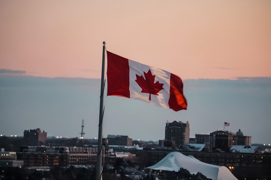 Canadian flag hoisted at sunset