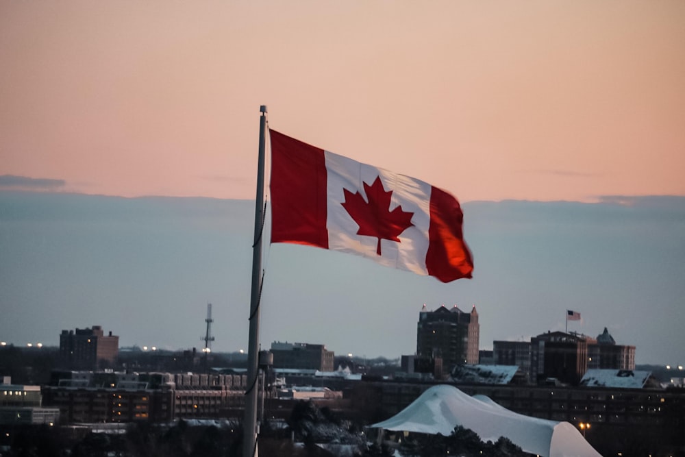 Canadian flag flying over city