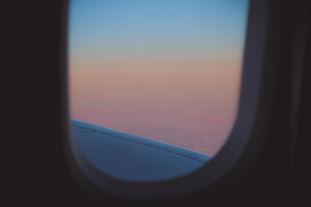 commercial plane window with view of ocean
