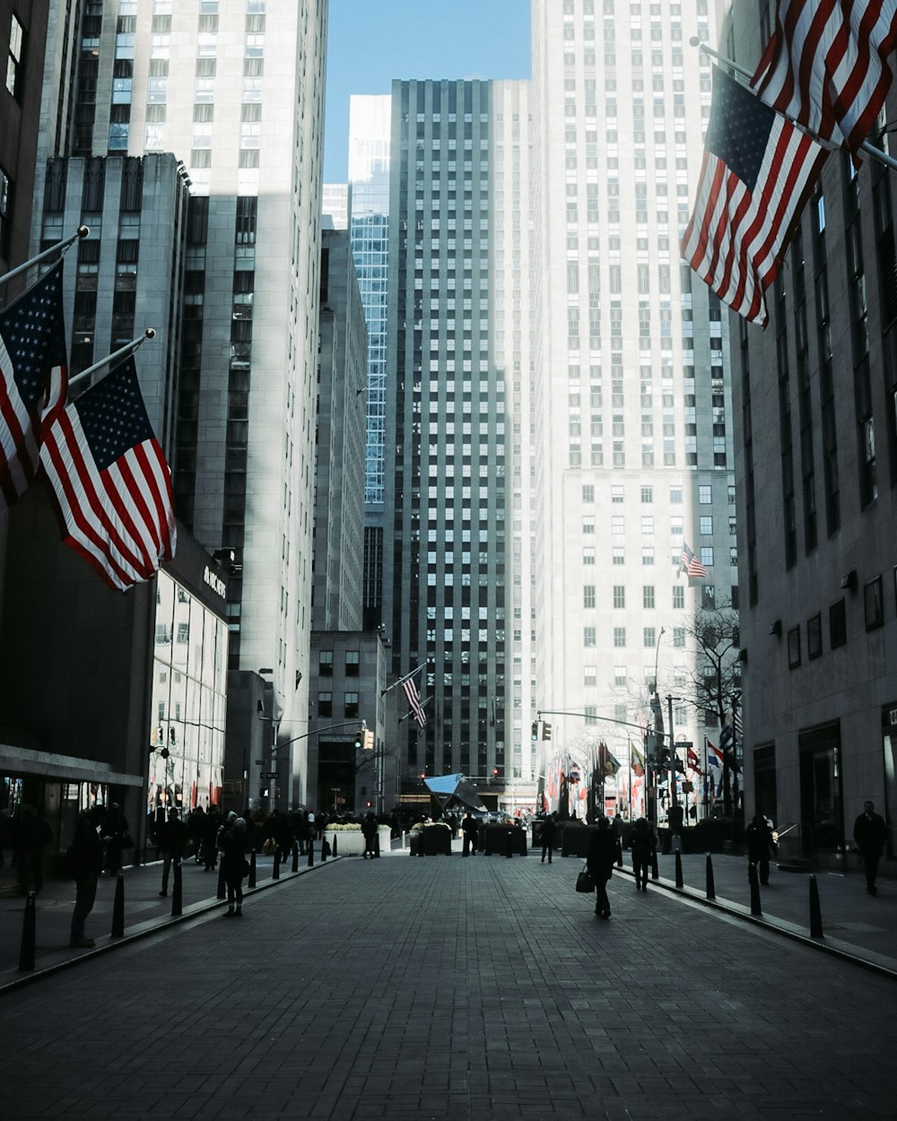 four US flags across white tall building