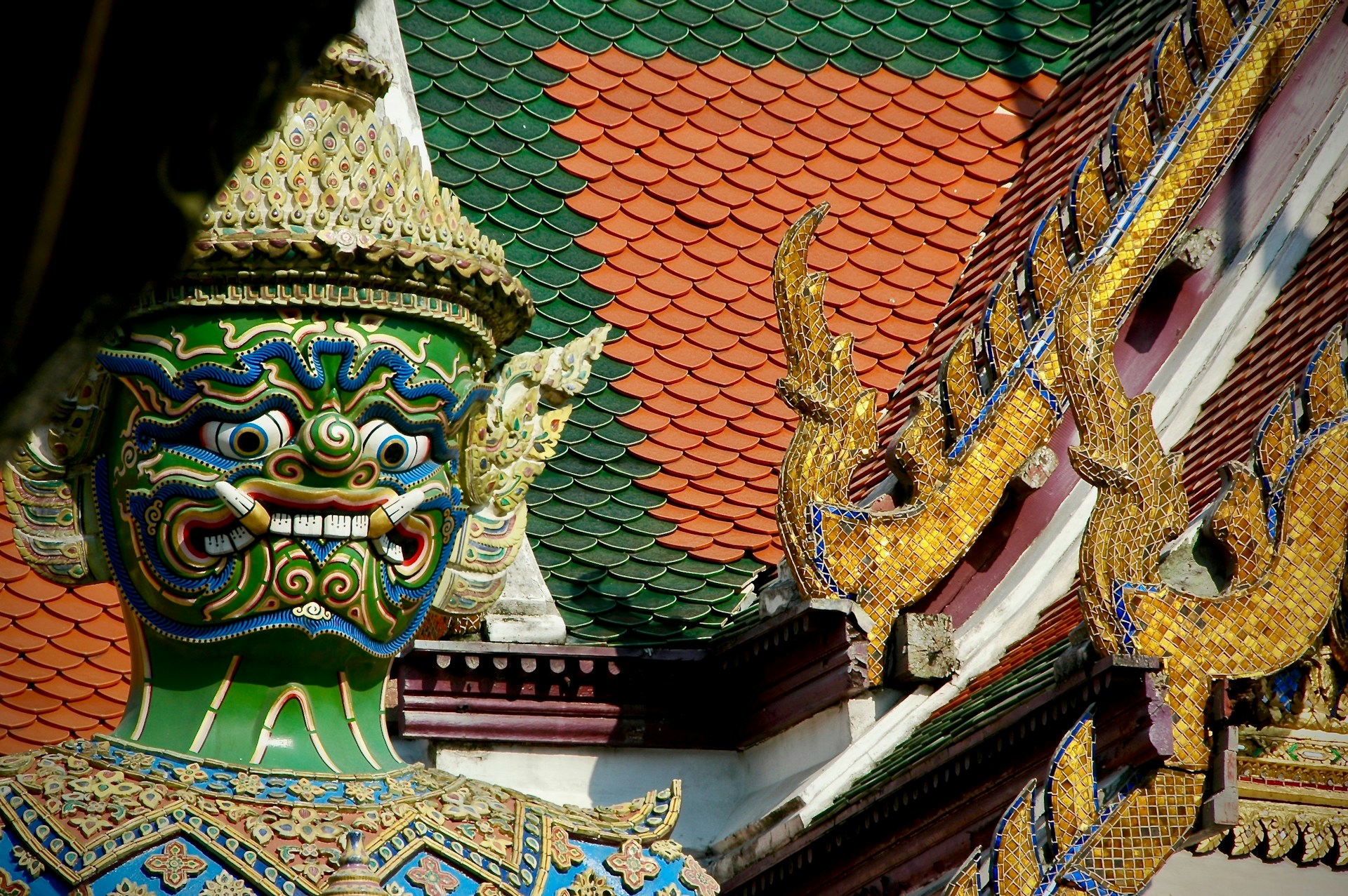 a close up of a dragon head on a building