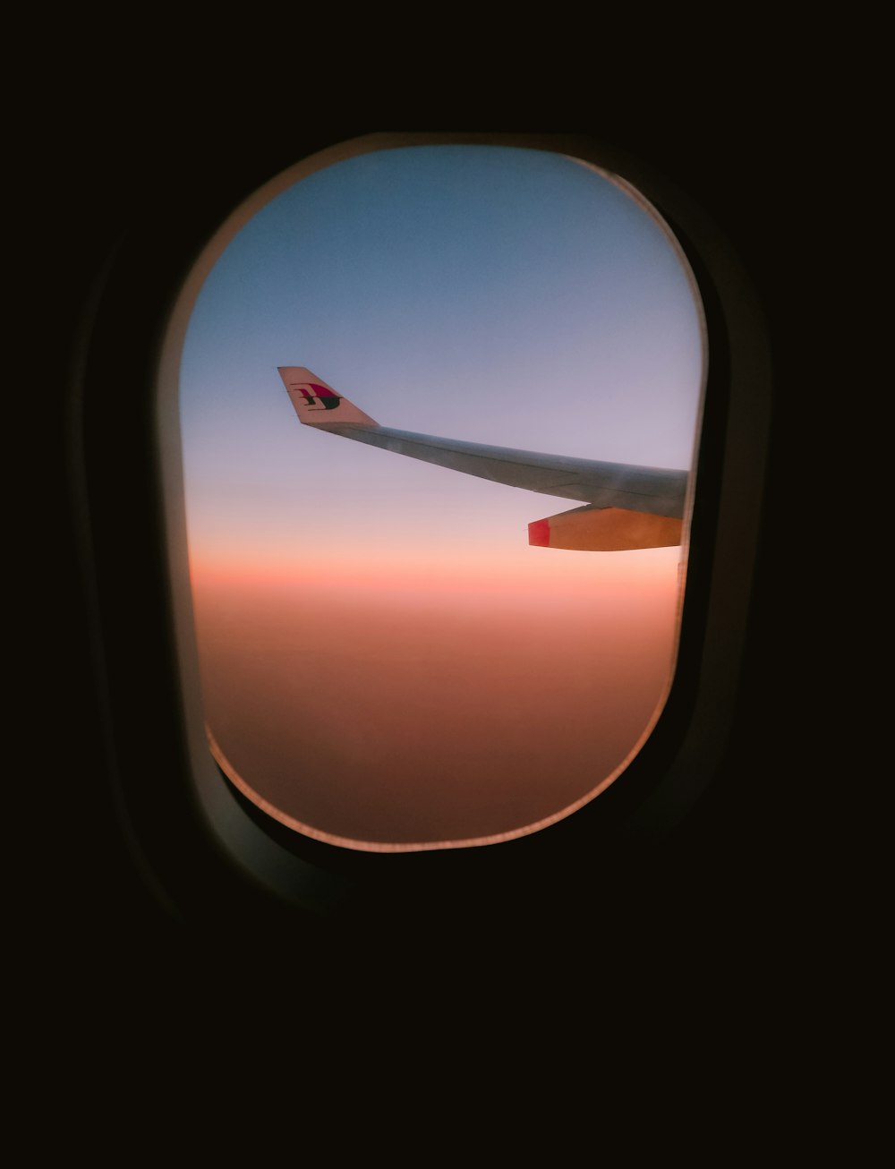 a view of the wing of an airplane through a window