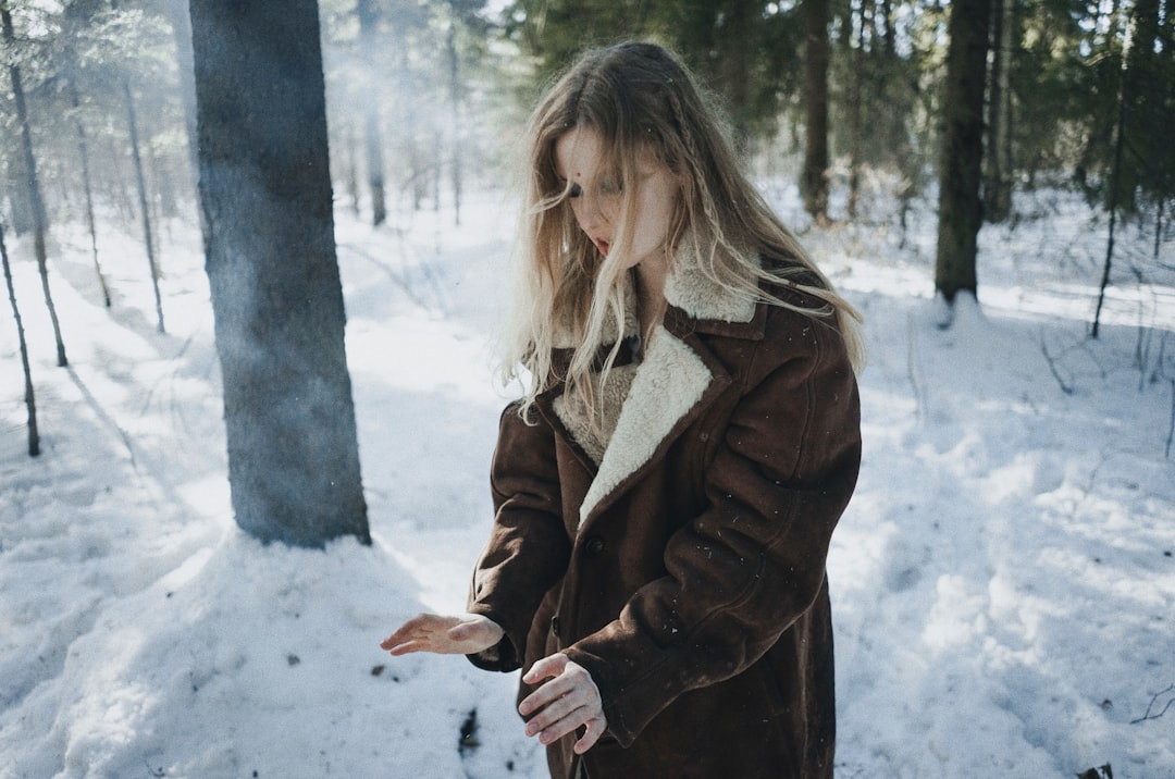 shallow focus photo of woman in brown jacket