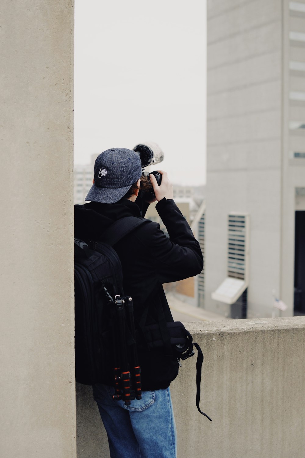 man taking photo of concrete building