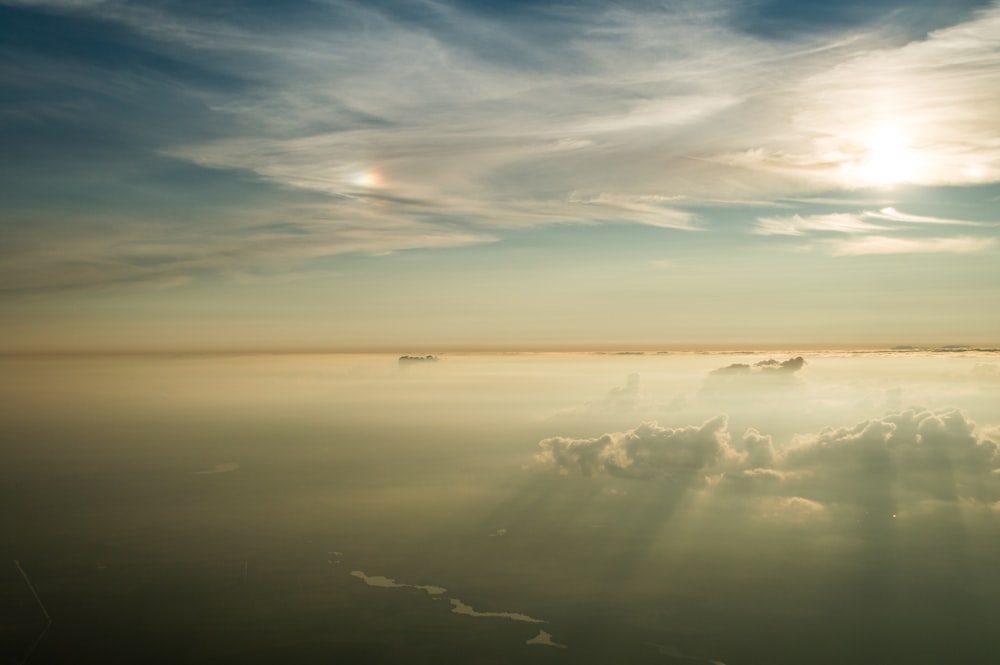 aerial photo of sun behind the clouds