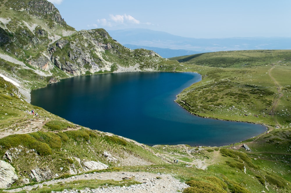 blue lake surrounded by mountains during daytime