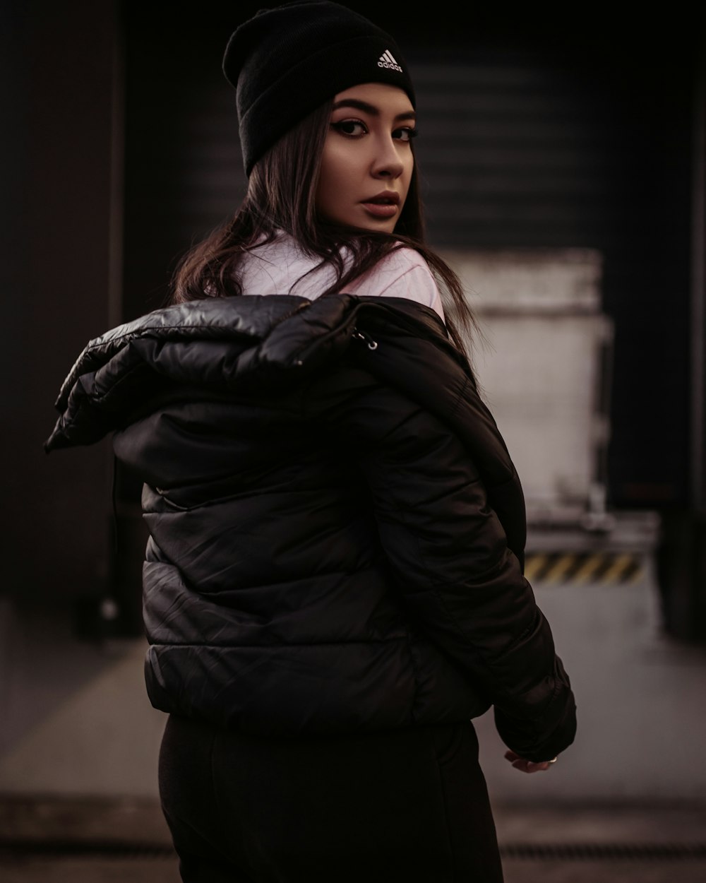 woman in black jacket turning head back